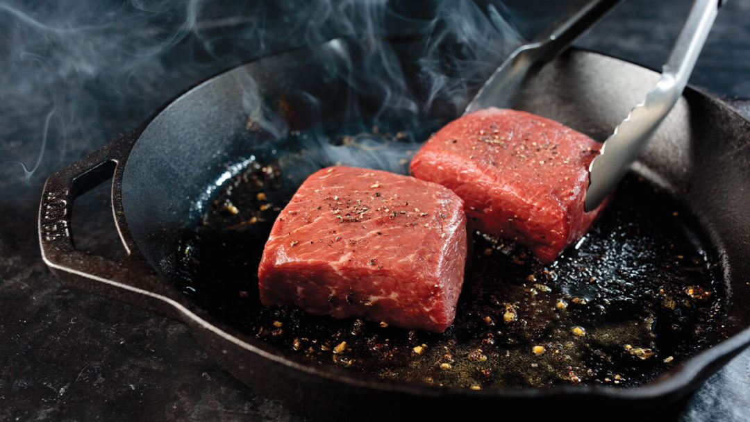 Cooking top sirloin steak in a cast iron skillet
