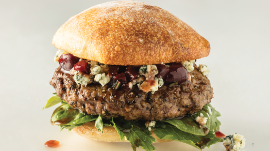gourmet cheeseburgers with blue cheese, lettuce and sauce with white background