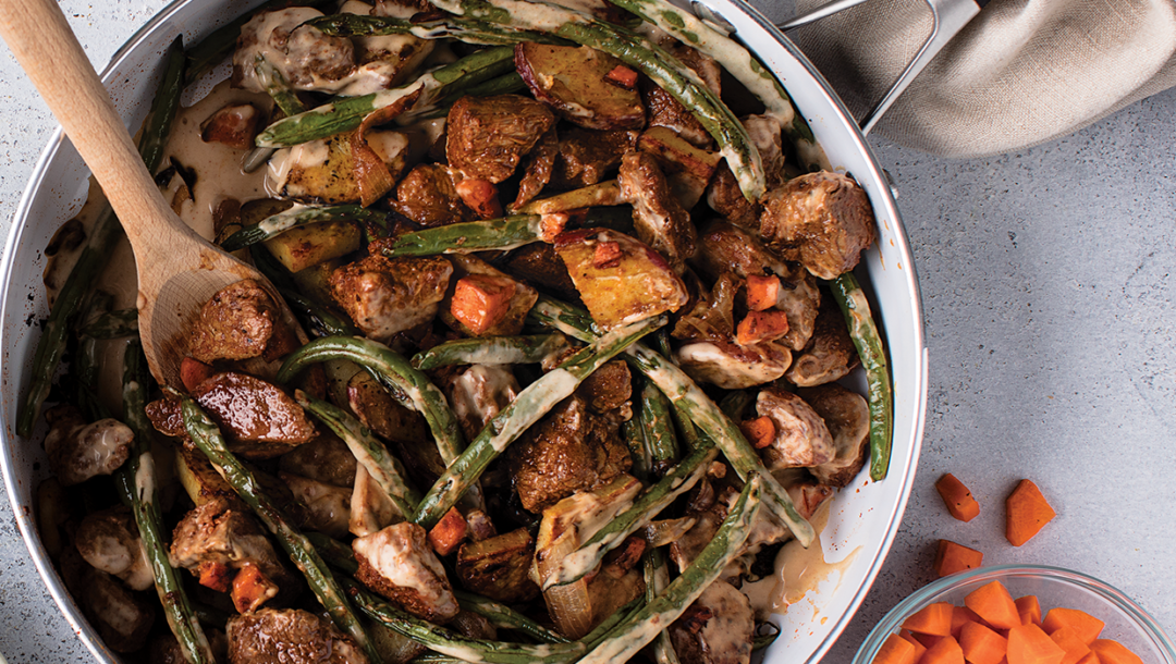Dijon steak and potatoes with green beans in skillet