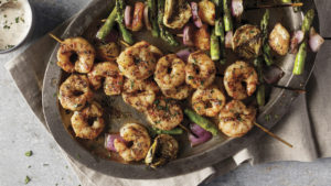 shrimp on the barbie plated with fresh vegetables