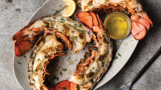 Grilled lobster tails served with melted butter and lemon