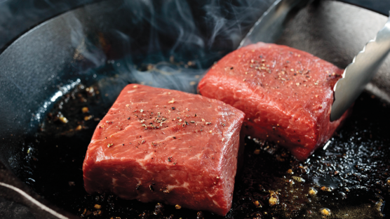 top sirloin cooking in a cast iron skillet