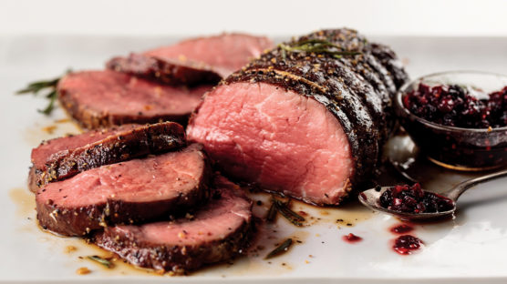 chateaubriand roast sliced with cranberry sauce