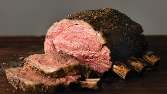 Bone-in frenched prime rib roast cooked and sliced