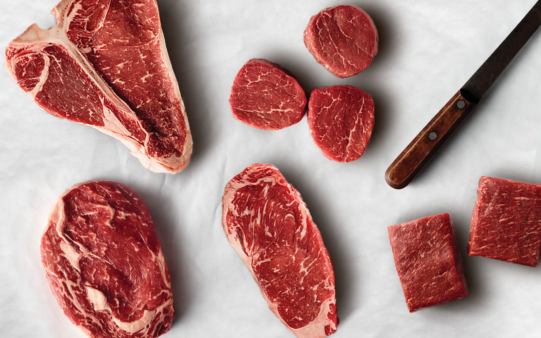 How to pick a perfect steak with the ultimate steak cut guide. Shown here is the following steak cuts: T-bone, ribeye, flat iron, filet mignon, top sirloin on butcher paper