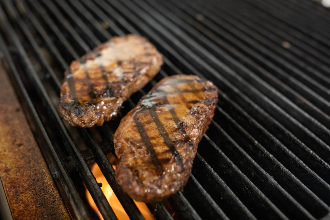 Bourbon maple glazed NY strip on grill