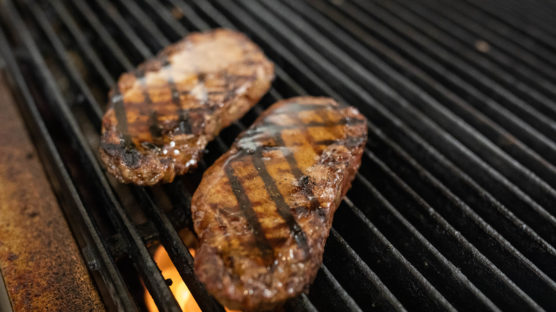 Bourbon maple glazed NY strip on grill