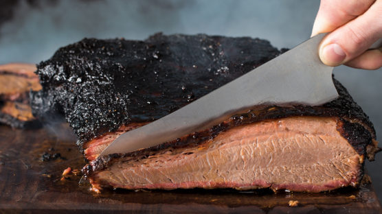 Slicing into a smoked beef brisket