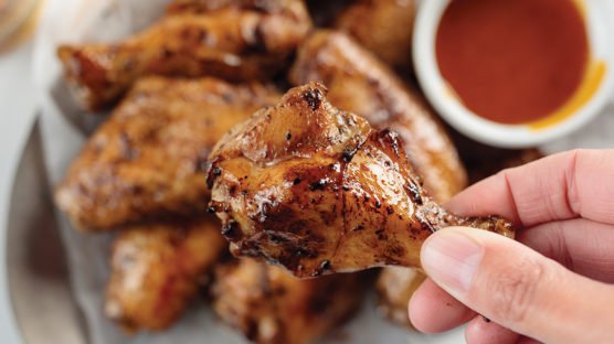 Man holding chicken wing