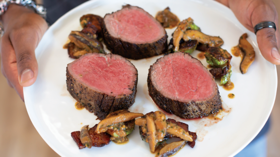 Slices of chateaubriand plated with miso glazed shiitake mushrooms