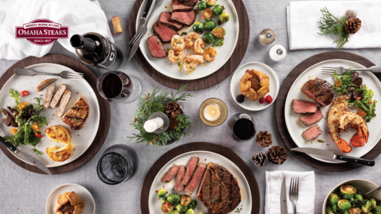 4 plates of surf and turf on holiday decorated table