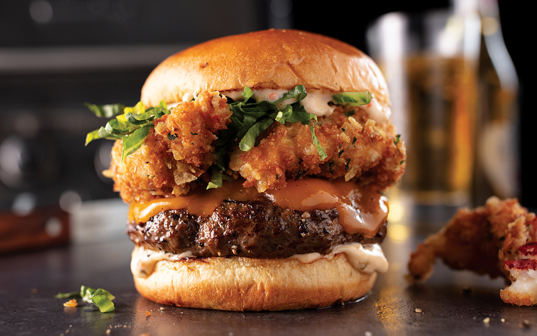 Fried lobster po boy cheeseburger with 1/2 pound all-beef grilled burger patties and yellow cheese on toasted brioche buns