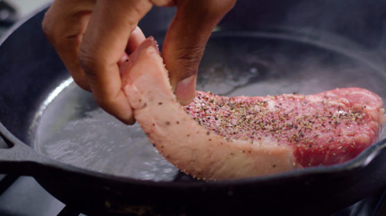 Cooking a New York strip steak in a cast iron pan indoors with Chef David Rose