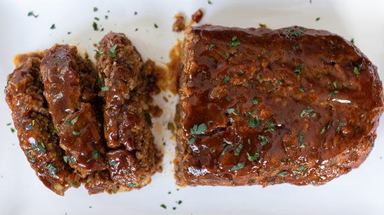 The best smoked barbecue meatloaf with Omaha Steaks premium ground beef, applewood-smoked steak cut bacon, BBQ potato chips, onion, green pepper, worcestershire sauce, garlic, and a sweet, tangy bbq glaze