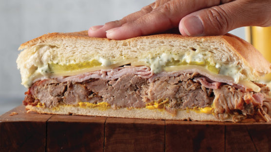 mojo braised pork butt sandwich with cilantro-garlic aioli on cuban bread