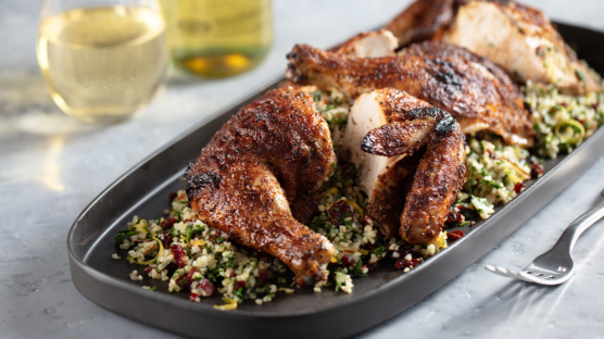Family platter of grilled moroccan-spiced spatchcock chicken served with dried cherry tabbouleh salad and beverages