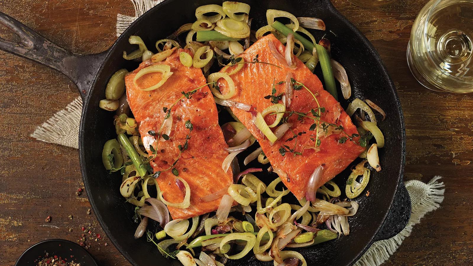 Baked Wild Salmon with Lemon Cast iron pan with 2 pieces wild salmon and sliced green onions