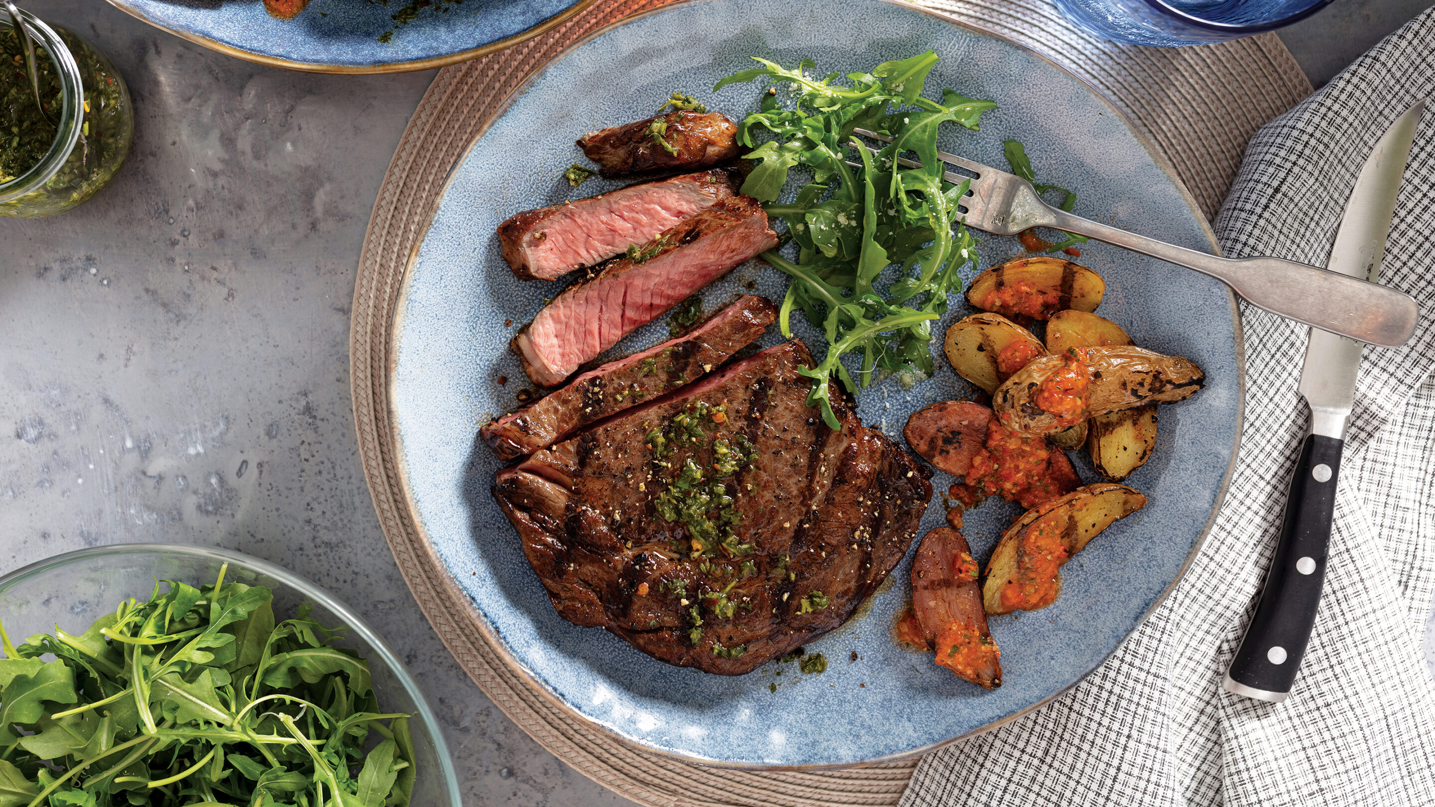 blogwp_grilled-ribeye-with-argula-salsa-verde-scaled Grilled Ribeye with Arugula Salsa Verde and Grilled Fingerling Potatoes with romesco sauce served on a plate