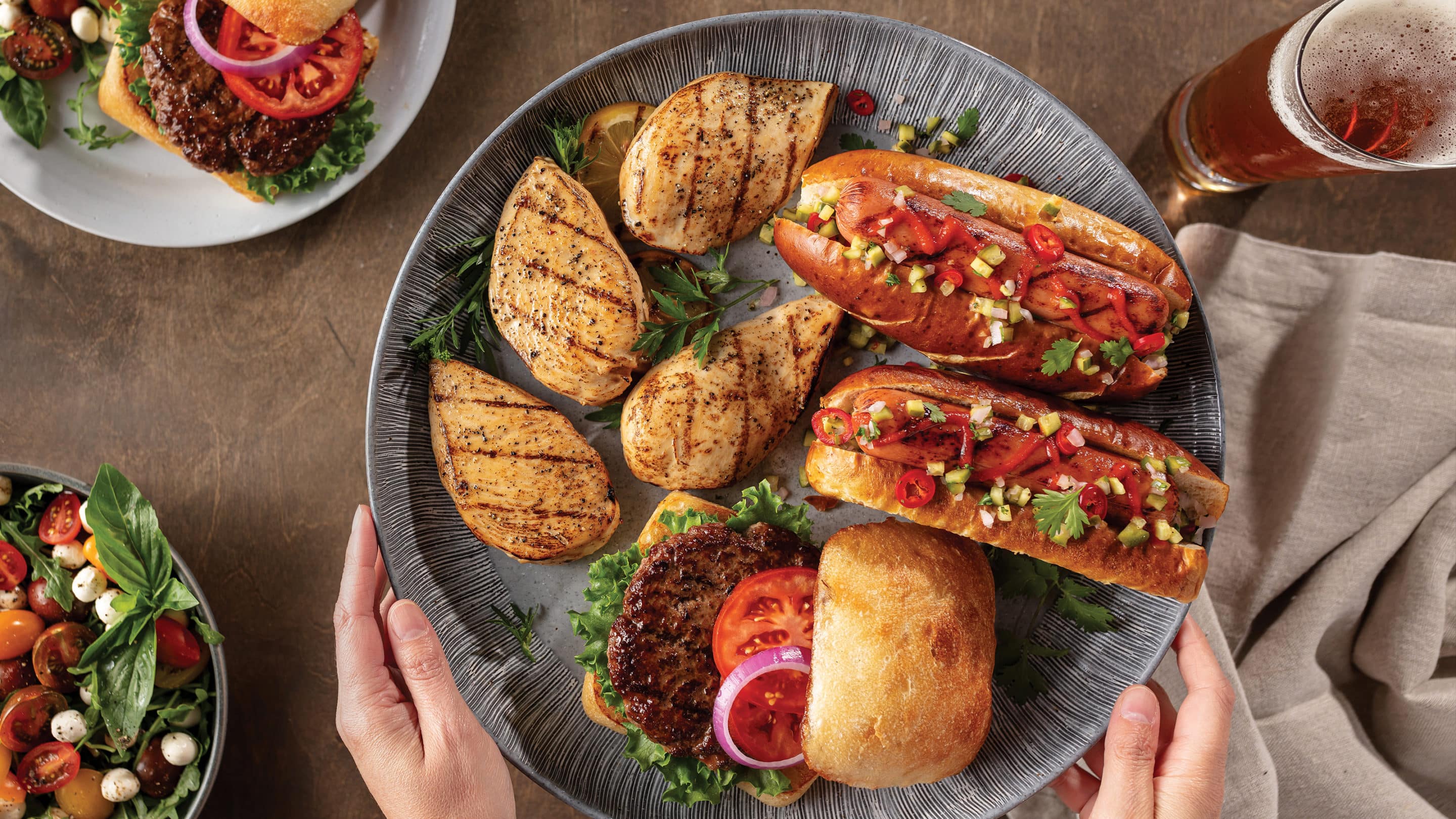 chicken breasts, hot dogs and hamburger on serving tray