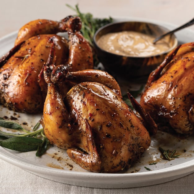seasoned cornish game hens on white plate