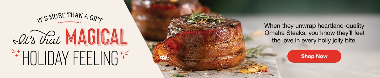 Bacon-wrapped Omaha Steaks filet mignon garnished with rosemary, alongside holiday-themed text that reads 'It’s More Than a Gift, It’s That Magical Holiday Feeling. Shop Now.'