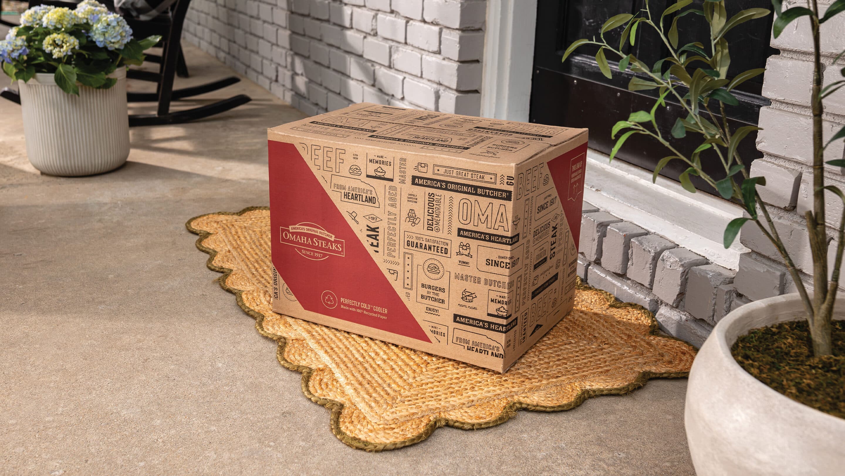 pair of hands opening Father's Day gift package of Omaha Steaks